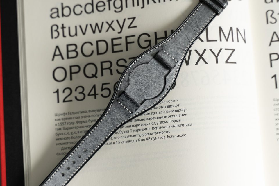 Full grey Bund strap laid across a typography book.