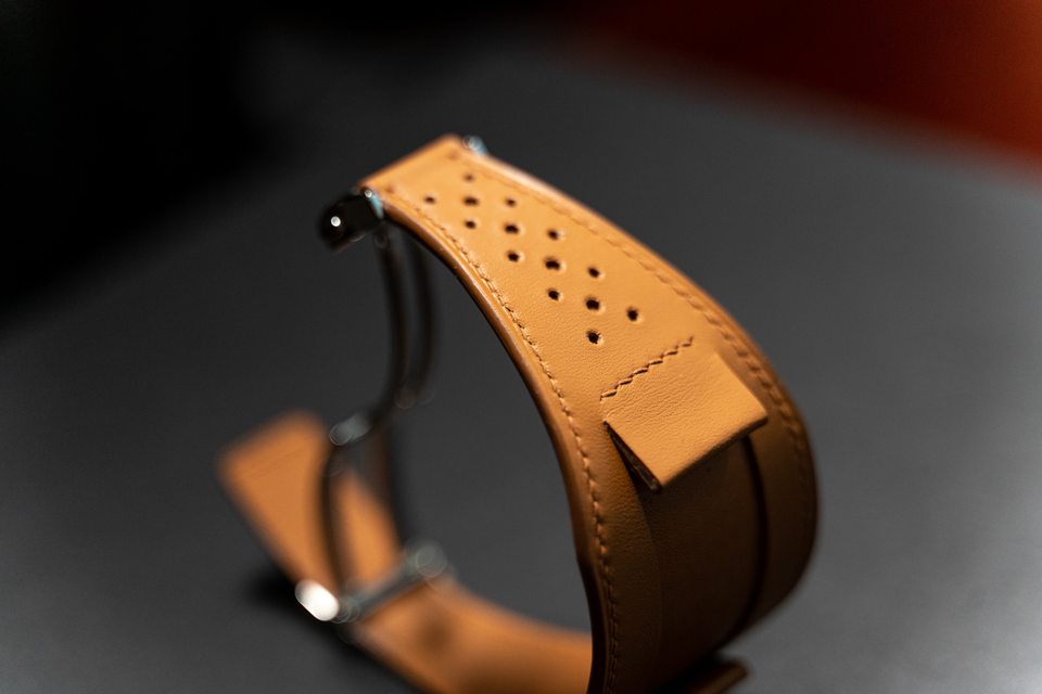 Tan perforated Bund design assembled into a loop against a dark background.